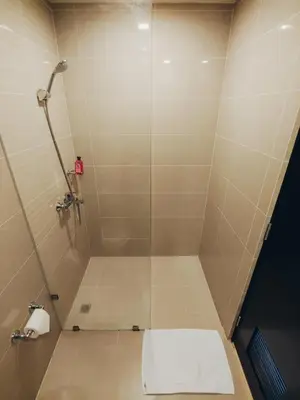 a bathroom with a shower with a toilet at Perfect for Working, Quiet & Relaxing at Uptown BGC in Manila