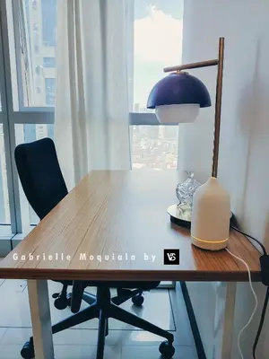 a desk with a lamp and a plate on a table at Perfect for Working, Quiet & Relaxing at Uptown BGC in Manila