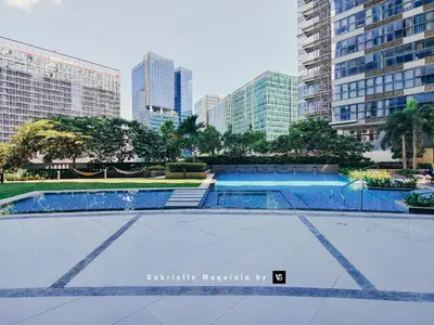 a swimming pool in a city with tall buildings at Perfect for Working, Quiet & Relaxing at Uptown BGC in Manila