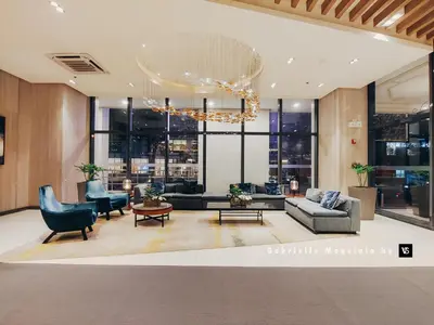 a living room with a couch and a chandelier at Perfect for Working, Quiet & Relaxing at Uptown BGC in Manila