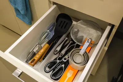 a drawer with scissors and other kitchen utensils at Spacious 2BR Apartment in BGC with Workspace & Washer in Manila