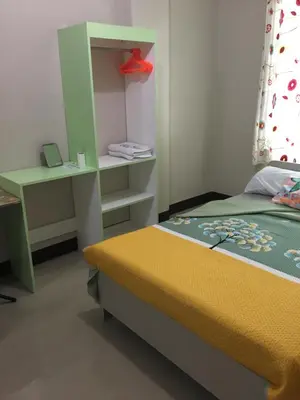 a small bedroom with a bed and a desk at AGB Anchorage Inn, studio room in Manila