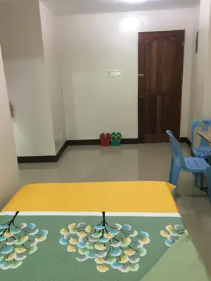 a room with a table with flowers on it at AGB Anchorage Inn, studio room in Manila