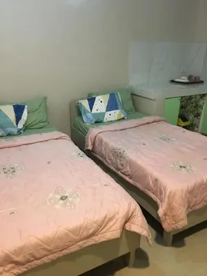 two beds sitting next to each other in a room at AGB Anchorage Inn, studio room - 2 single beds in Manila