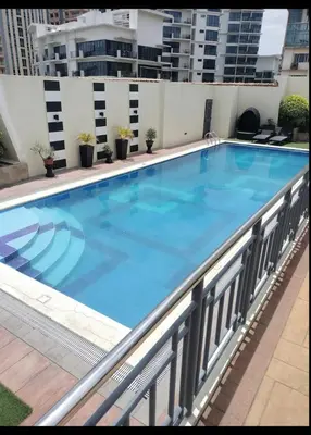 a large swimming pool on top of a building at Cozy Starpad14R Stamford McKinley Hill in Manila