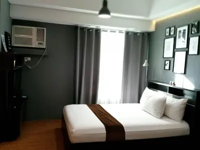 a bedroom with a bed and a window at Studio unit at The Beacon Makati near Greenbelt in Manila