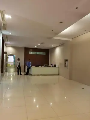 two men standing in a waiting room in a building at Studio unit at The Beacon Makati near Greenbelt in Manila