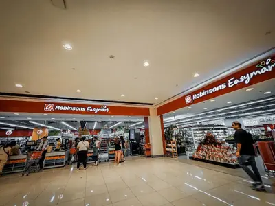 a store with people walking through a shopping mall at Sunny Spot in Manila