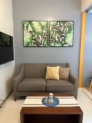 a living room with a couch and a coffee table at Executive Suite in Bonifacio Global City in Manila