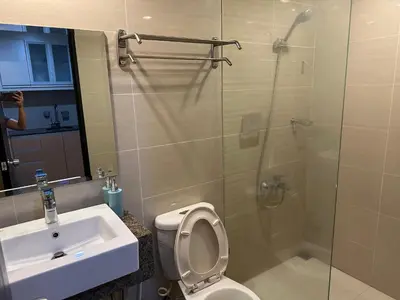 a bathroom with a shower and a toilet and a sink at Executive Suite in Bonifacio Global City in Manila
