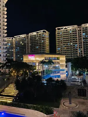 a view of a hotel at night with buildings at cozy and minimalist room near airport in Manila