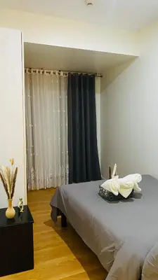 a bedroom with a large bed and a window at cozy and minimalist room near airport in Manila