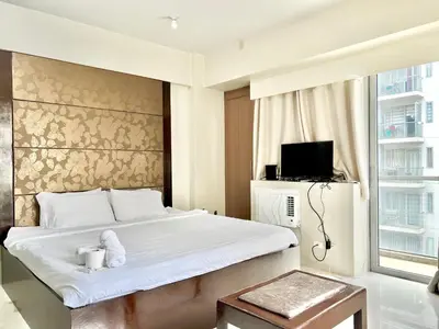 a bedroom with a bed with a teddy bear on it at Cozy Spacious Condo Hotel near NAIA Manila Airport Pasay in Manila