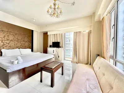 a bedroom with a large bed and a couch at Cozy Spacious Condo Hotel near NAIA Manila Airport Pasay in Manila