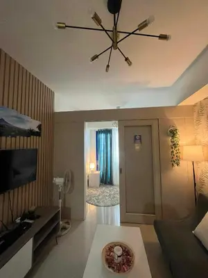 a living room with a ceiling fan and a living room at BH Crib - Staycation near Mall of Asia Complex in Manila