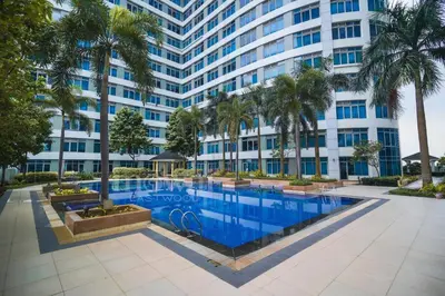 an image of a building with a swimming pool and palm trees at 400mpbs, Free pool access! Eastwood LeGrand 3 - Mowai Suites in Manila