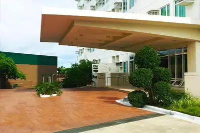 a building with a large patio in front of it at Studio Getaway in Alabang at Anuva Residences in Manila