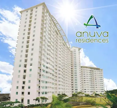 a large white building with the amuvores logo on it at Studio Getaway in Alabang at Anuva Residences in Manila