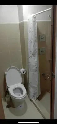 a bathroom with a toilet and a shower stall at Cozy Private Condo at Shore 3 near MOA in Manila