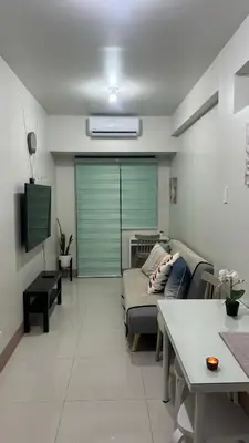 a living room with a couch and a table at Cozy Private Condo at Shore 3 near MOA in Manila