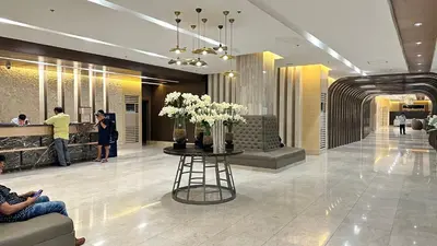 a lobby with a table with flowers on it at Cozy Private Condo at Shore 3 near MOA in Manila