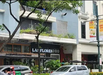 a building with a sign that reads lax phones at Cozy Pad BGC in Manila