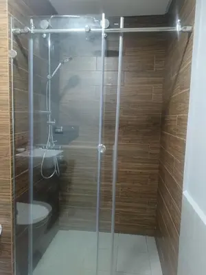 a bathroom with a glass shower with a toilet at The Radiance Manila Bay Studio 2 in Manila