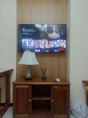 a table with a lamp and a tv on a wall at The Radiance Manila Bay Studio 2 in Manila