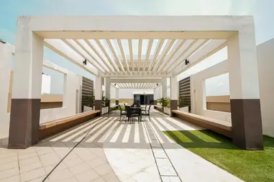a patio with tables and chairs in a building at The Radiance Manila Bay Studio 2 in Manila
