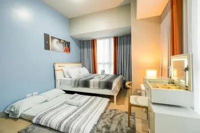 a bedroom with two beds and a mirror at Luxurious 2 Bedroom in Uptown BGC Taguig in Manila