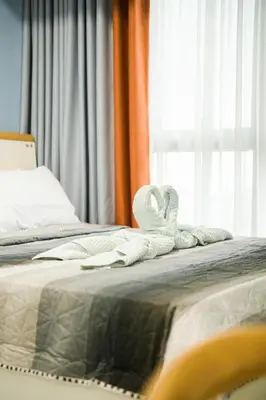 a bed with white towels on it with a window at Luxurious 2 Bedroom in Uptown BGC Taguig in Manila