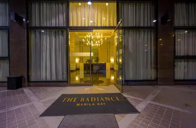 a welcome mat in front of a building with a chandelier at The Radiance Manila Bay Studio in Manila