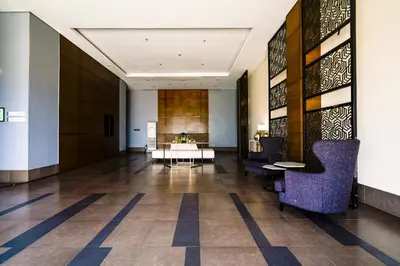 a lobby of a hotel with a table and chairs at The Radiance Manila Bay Studio in Manila