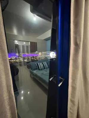 a view of a room with a bed and a mirror at Sea Residences Yeshua infront of MOA Pasay in Manila