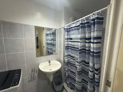 a small bathroom with a sink and a mirror at Sea Residences Yeshua infront of MOA Pasay in Manila