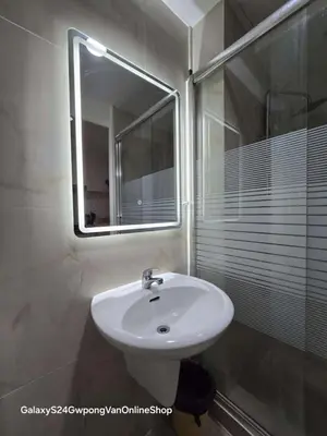 a bathroom with a sink and a mirror at Sea Residences Yeshua infront of MOA Pasay in Manila
