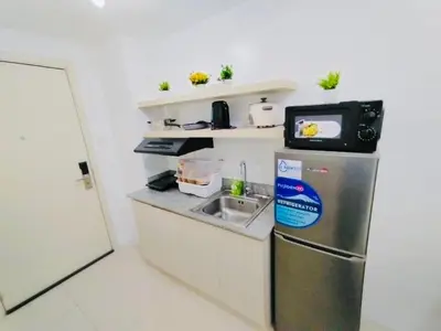 a small kitchen with a sink and a refrigerator at Hotel Luxury Twin Bed Room with Balcony Las Pinas-South Residence in Manila