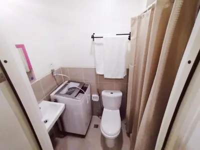 a small bathroom with a toilet and a sink at Hotel Luxury Twin Bed Room with Balcony Las Pinas-South Residence in Manila