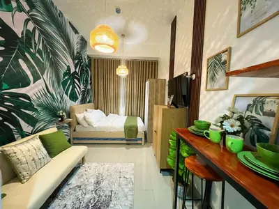 a living room with a couch and a bed at Samuel staycation in Smdc Green2 one studio unit in Dasmariñas