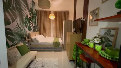 a small living room with a bed and a couch at Samuel staycation in Smdc Green2 one studio unit in Dasmariñas