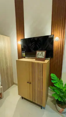 a wooden cabinet with a picture on top of it at Samuel staycation in Smdc Green2 one studio unit in Dasmariñas