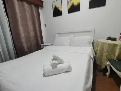 a white bed with a towel on top of it at romantic makati in Manila