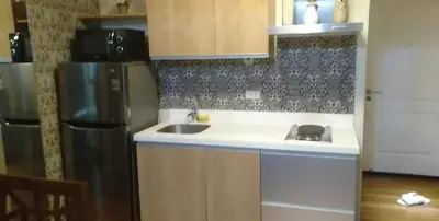 a kitchen with a black refrigerator and a sink at Azure Urban Residence A11 Near Airport and SM Bicutan+ Free wifi in Manila
