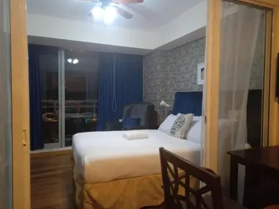 a bedroom with a white bed and a window at Azure Urban Residence A11 Near Airport and SM Bicutan+ Free wifi in Manila