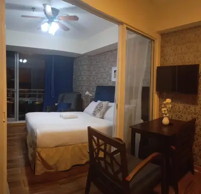 a bedroom with a bed and a ceiling fan at Azure Urban Residence A11 Near Airport and SM Bicutan+ Free wifi in Manila