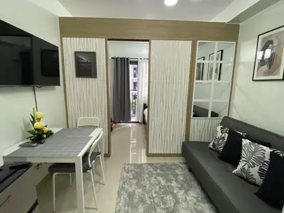 a living room with a couch and a table at SHORE RESIDENCE D15 shortwalk Mall of asia near airport in Manila