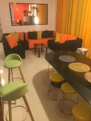 a living room with a couch and a table and chairs at La Coccinella in Manila