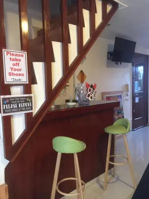 a bar with two green stools in a kitchen at La Coccinella in Manila