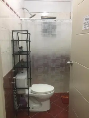 a bathroom with a toilet and a shower at La Coccinella in Manila