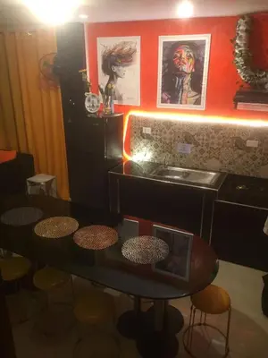 a dining room with a table and a sink at La Coccinella in Manila